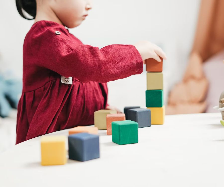 Kind baut mit Bauklötzen